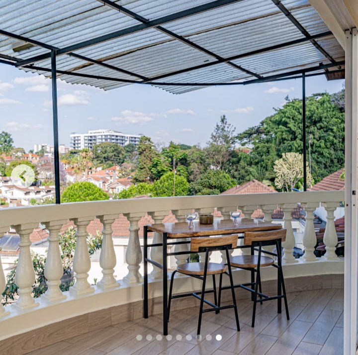Cozy private balcony overlooking lush green garden at Grove Penthouse in Brookside