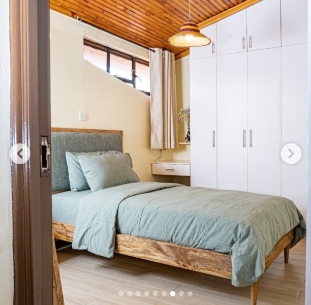 Elegant master bedroom with natural light and tranquil garden view at Grove Penthouse