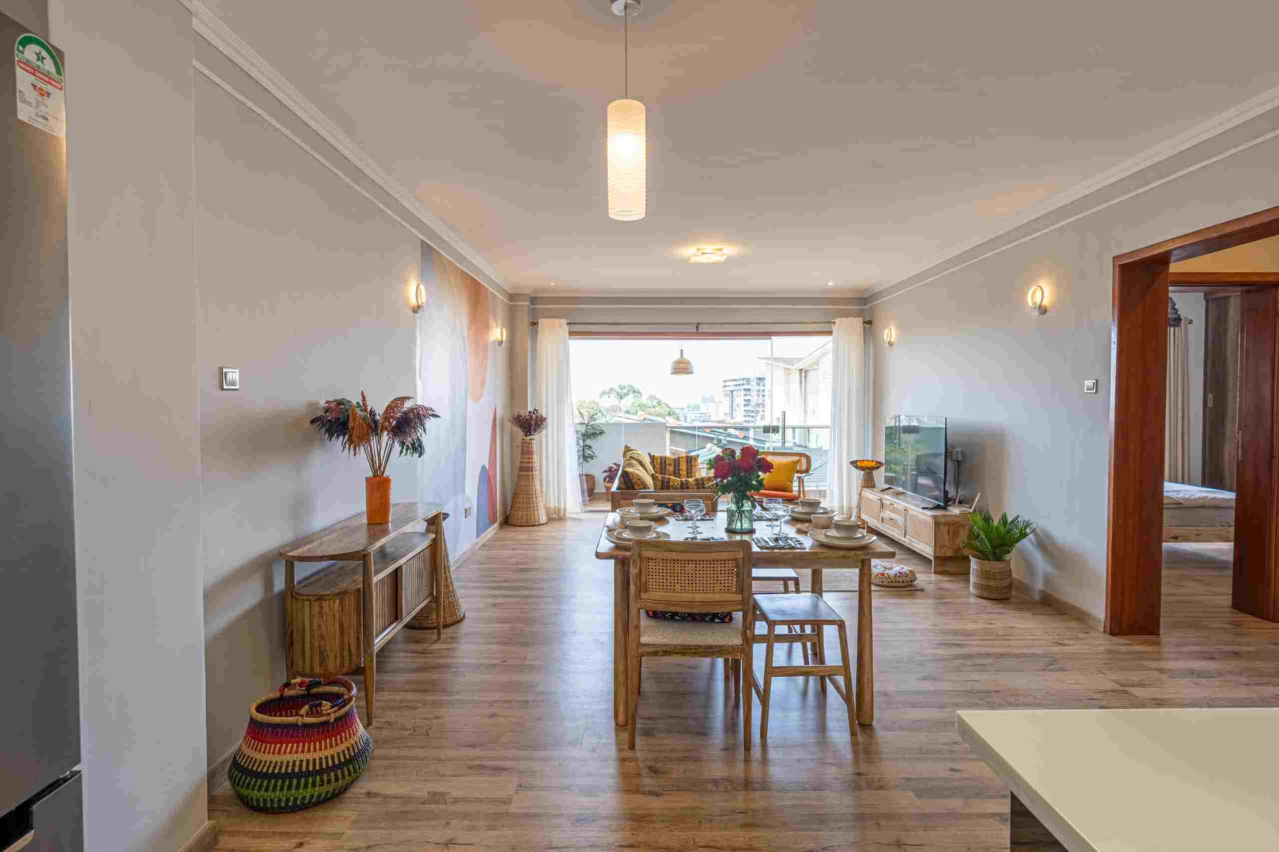 Stylish dining area with modern furnishings and ample natural light at Grey Pearl Apartments