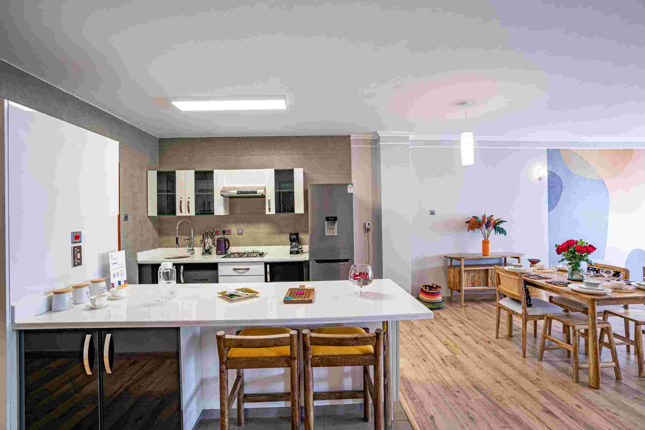 Stylish dining area with modern furnishings and ample natural light at Grey Pearl Apartments