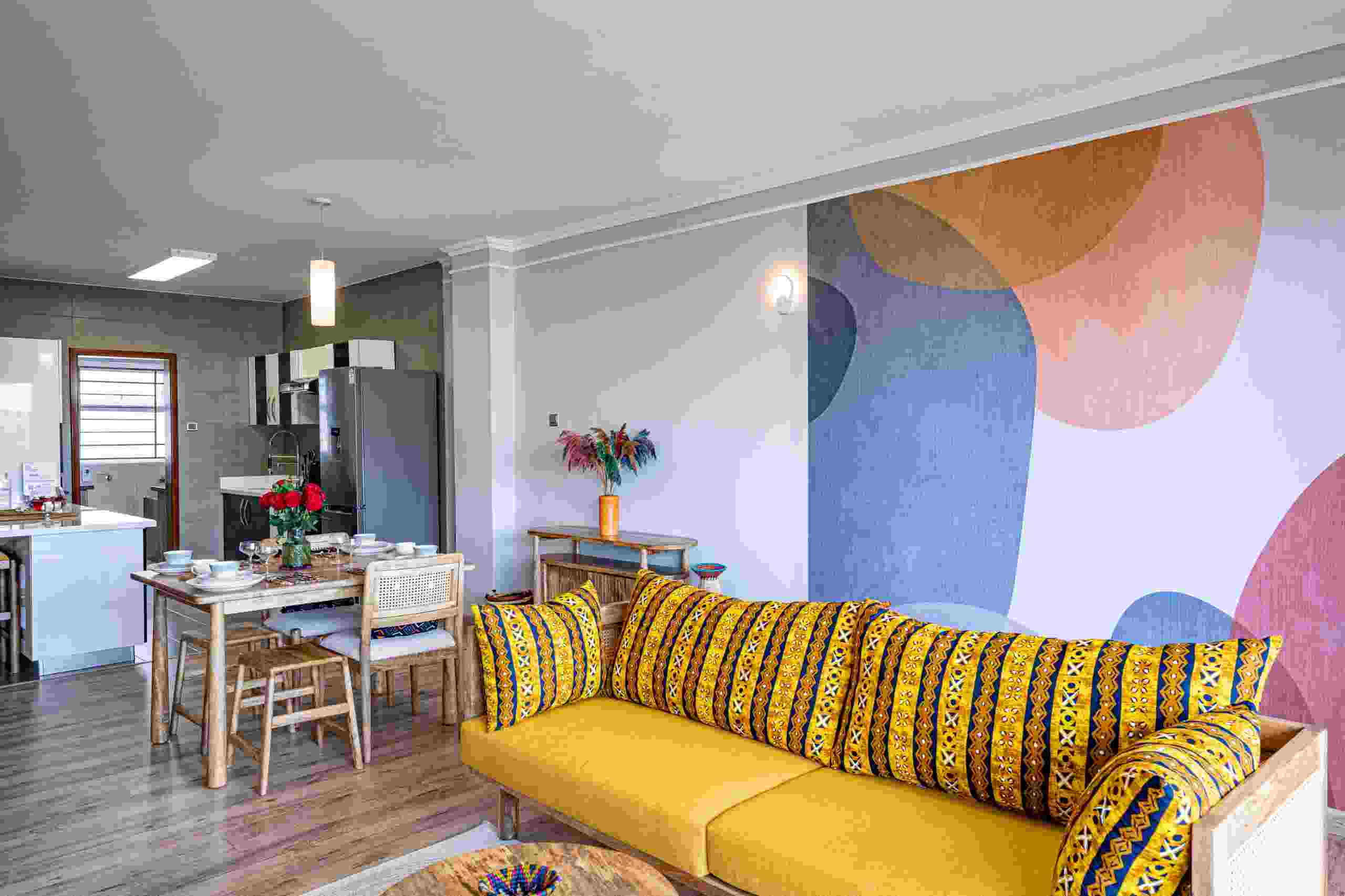 Spacious living room with natural light and modern furnishings at Grey Pearl Apartments