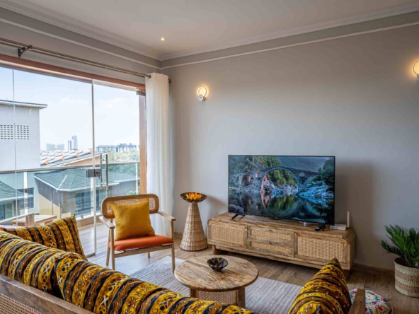 Spacious living room with natural light and modern furnishings at Grey Pearl Apartments