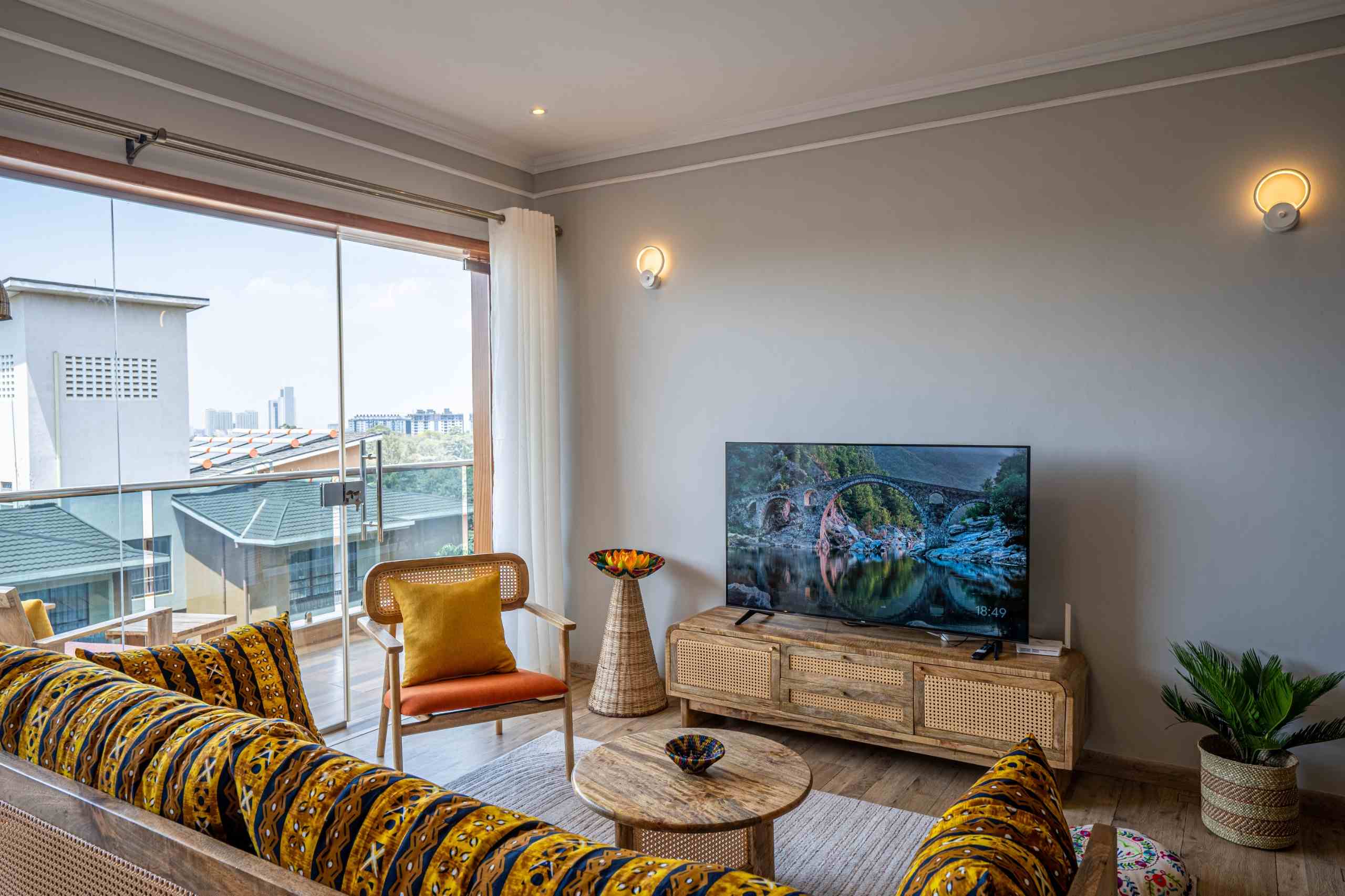 Spacious living room with natural light and modern furnishings at Grey Pearl Apartments