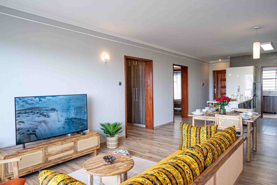 Spacious living room with natural light and modern furnishings at Grey Pearl Apartments