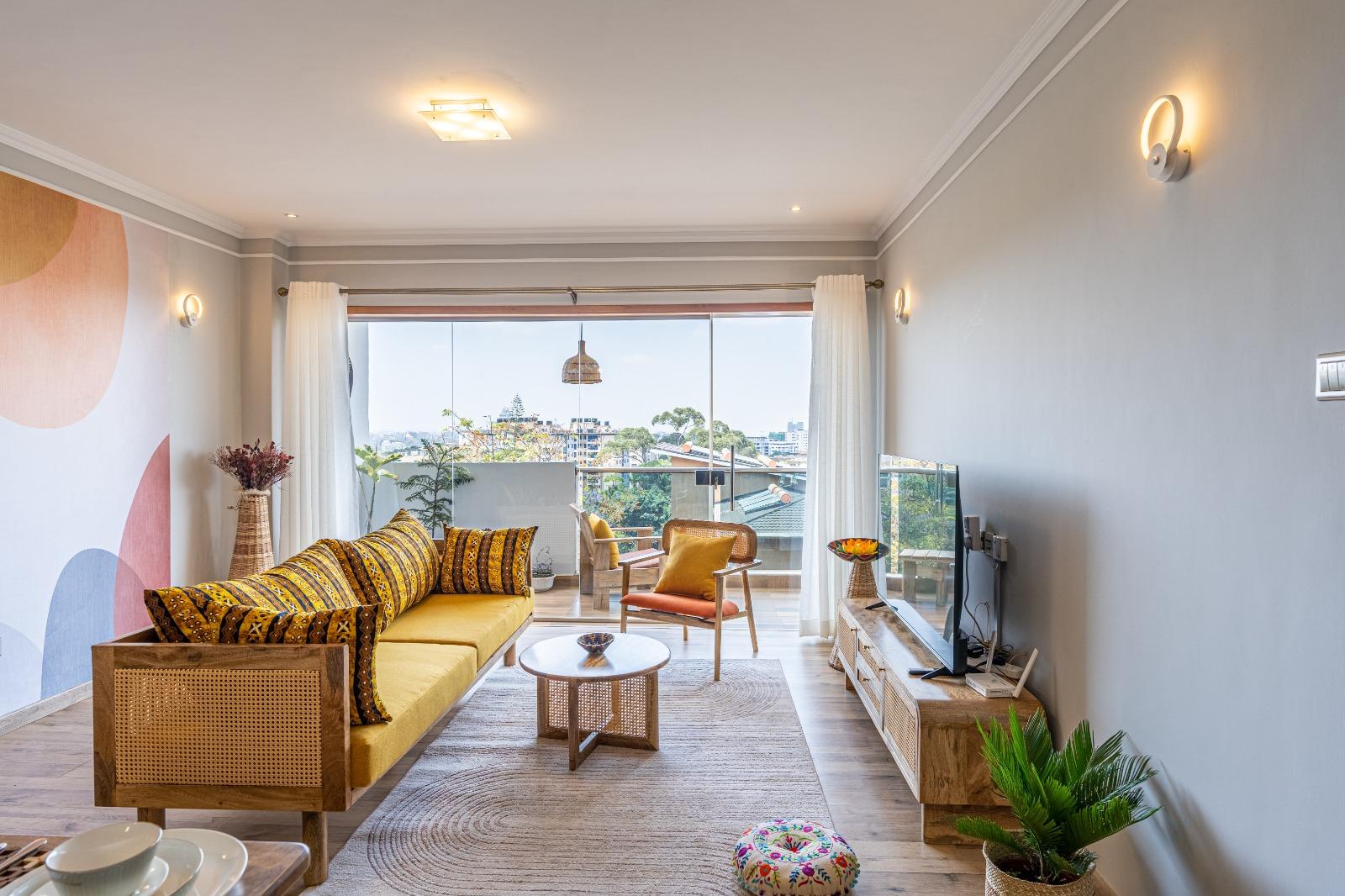 Spacious living room with natural light and modern furnishings at Grey Pearl Apartments